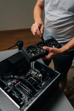Vertical cropped shot of unrecognizable computer technician brushing graphics Stock Photos