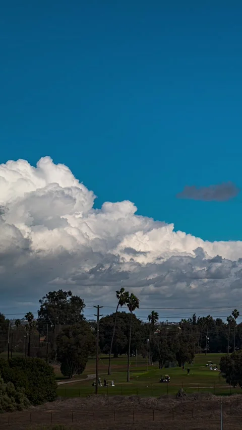 Vertical Cumulus Clouds Build Above Los Angeles Golf Course Video stock 322736412