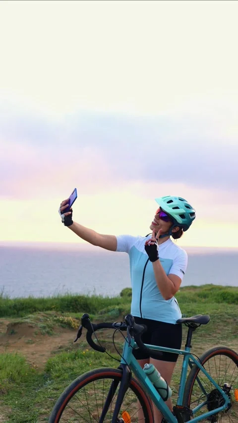 Vertical Cyclist Taking Selfie With Sea Sunrise in Background Stock Footage 309882980