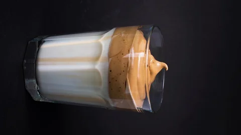 Vertical dalgona coffee making, whipped cold coffee with milk Stock Footage 129714021