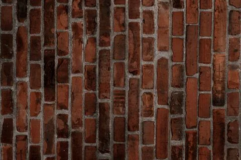 Vertical dark red brick wall texture. Abstract background pattern Stock Photos