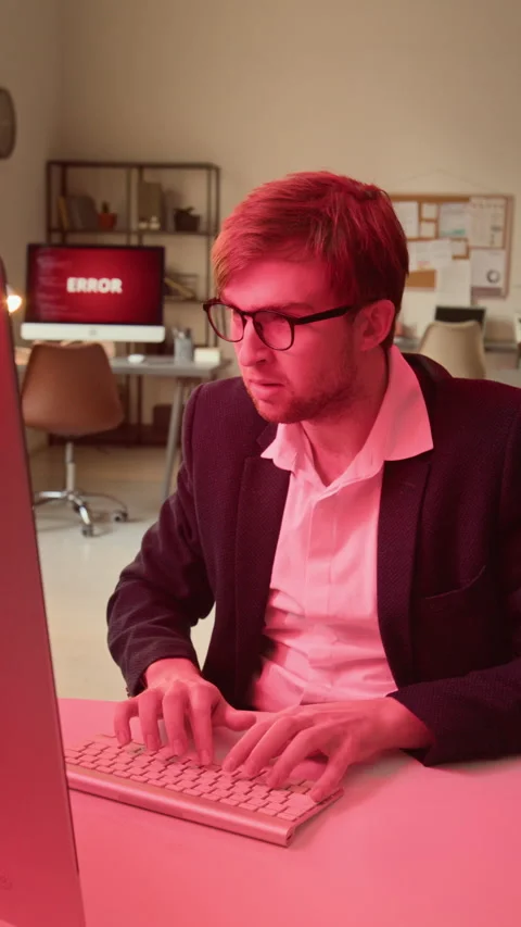 Vertical of Daunted Employee Trying to Remove Malware and Protect His Computer 動画素材 331560656