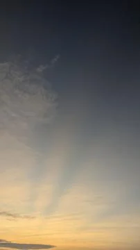 A vertical dawn landscape view captures delicate crepuscular sun rays shoot.. Stock Photos