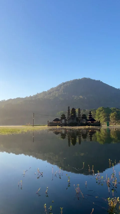 Vertical Daylight Reflection of Tamblingan Temple with Mountain Stock Footage 336379812