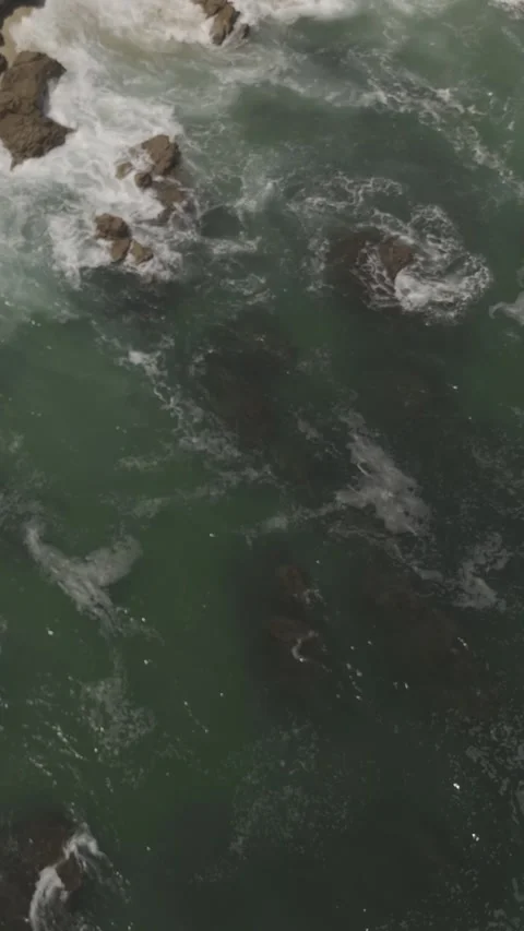 Vertical Decent and Pan of Waves Rocks Stock Footage 285566303