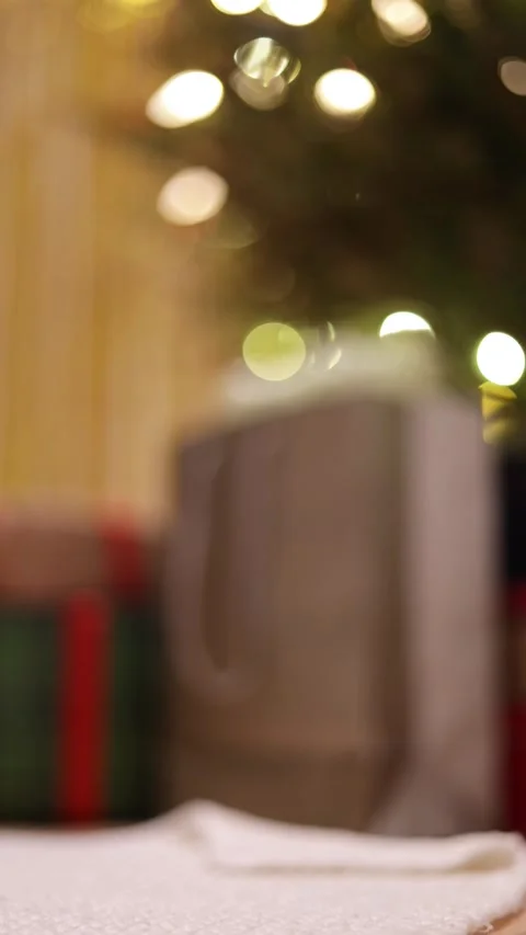 A Vertical Defocused Close Up Of A Gift Bag And Christmas Presents Under Tree Stock Footage 313702893