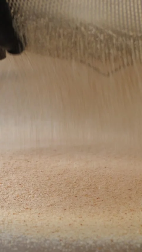 Vertical. Delicate breadcrumbs fall through sieve creating soft layer for shaped Video stock 324867007