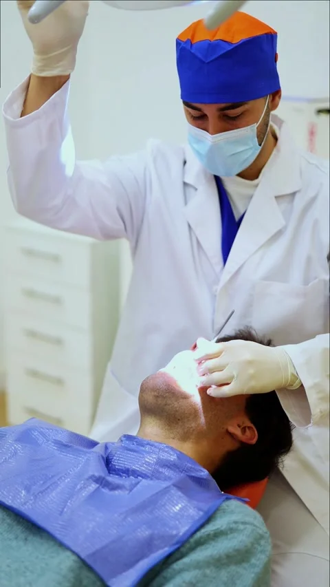 Vertical Dentist examining patient's teeth with dental mirror Stock Footage 295784576