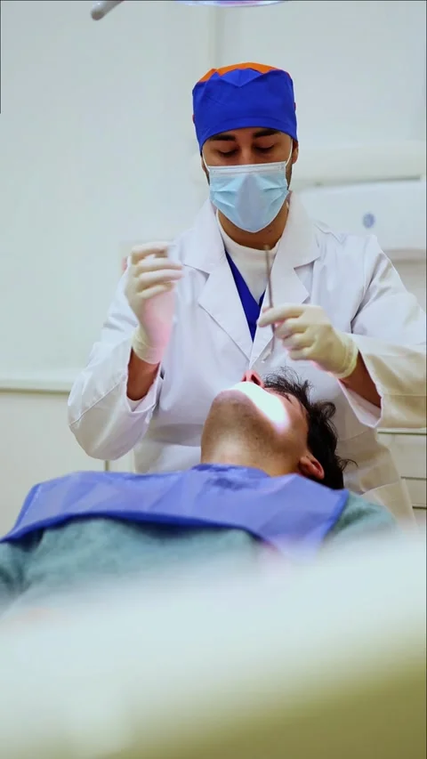 Vertical Dentist preparing syringe for anesthesia injection Stock Footage 295784575