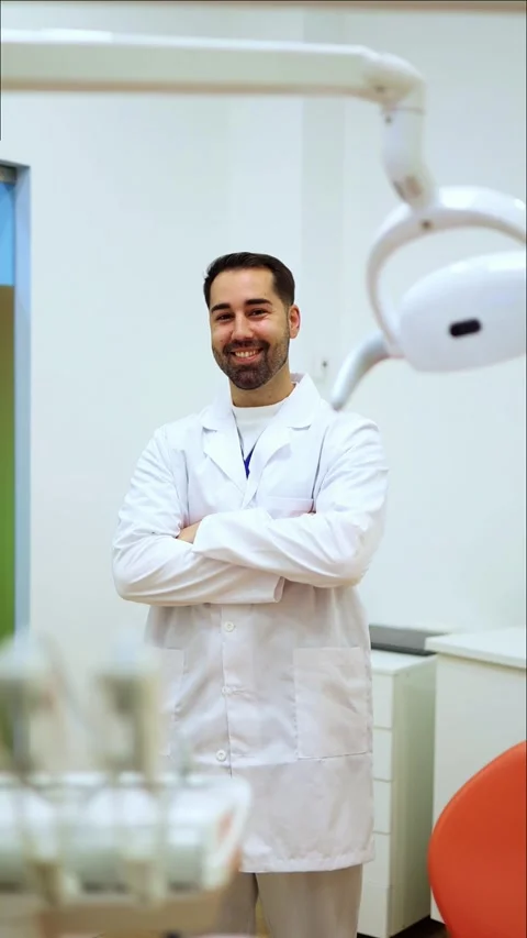Vertical Dentist smiling and posing in dental clinic Stock Footage 295784528
