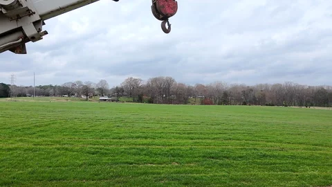 Vertical Descent From A Crane Hook To Green Grass Stock Footage 304693057
