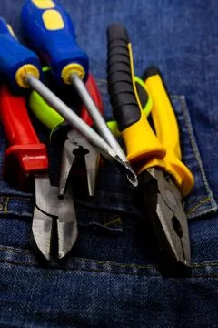 Vertical design engineer pair of screwdrivers nippers dark background pattern Stock Photos