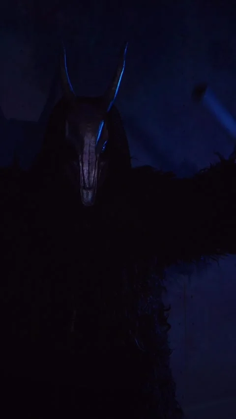 Vertical, The devil monster dances with RGB sticks in his hands. Stock Footage 301543659