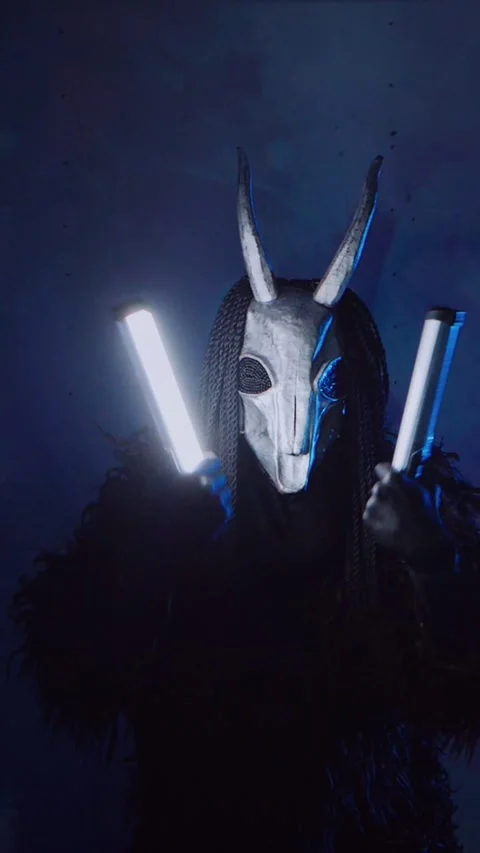 Vertical, The devil monster dances with RGB sticks in his hands. Stock Footage 301543736