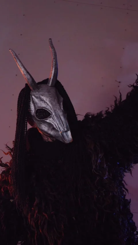 Vertical, The devil monster dances with RGB sticks in his hands. Stock Footage 301543806