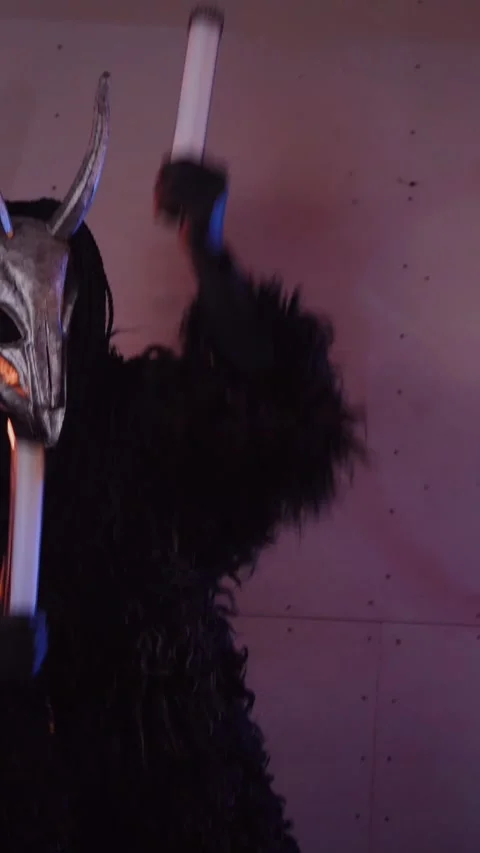 Vertical, The devil monster dances with RGB sticks in his hands. Stock Footage 301543819