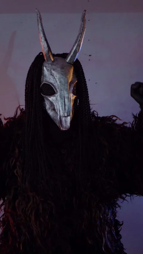 Vertical. The devil monster dances with RGB sticks in his hands. A mystical man Stock Footage 302732015