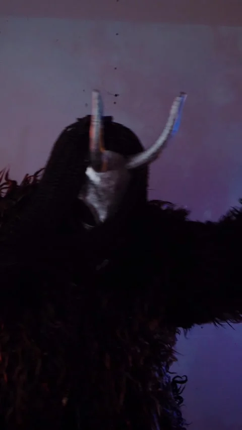 Vertical. The devil monster dances with RGB sticks in his hands. A mystical man Stock Footage 302732052