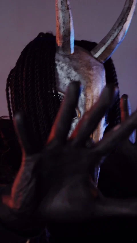 Vertical. The devil monster dances with RGB sticks in his hands. A mystical man Stock Footage 302732056