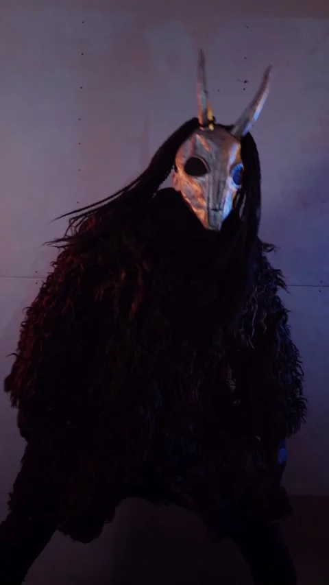 Vertical. The devil monster dances with RGB sticks in his hands. A mystical man Stock Footage 302732073