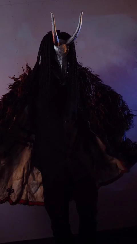 Vertical. The devil monster dances with RGB sticks in his hands. A mystical man Stock Footage 302732087