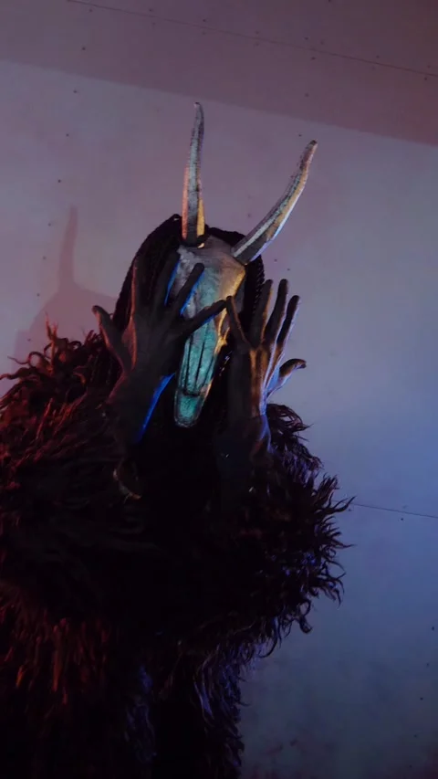 Vertical. The devil monster dances with RGB sticks in his hands. A mystical man Stock Footage 302732110