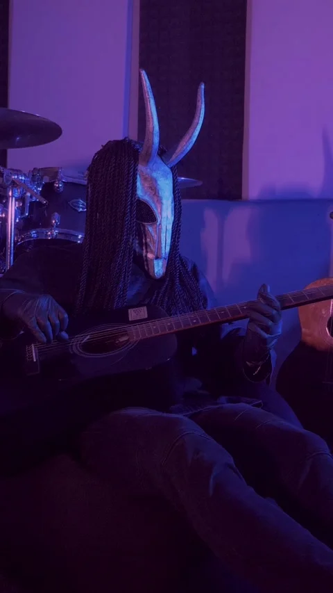 Vertical. The devil monster plays the guitar. A mystical man in a scary mask Stock Footage 302193261