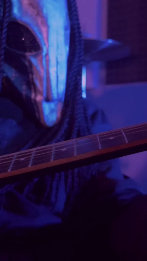 Vertical. The devil monster plays the guitar. A mystical man in a scary mask Stock Footage 302193284