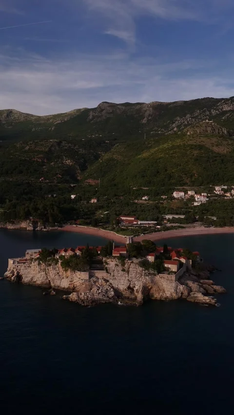 Vertical Distant Drone Orbit of Sveti Stefan Island Resort at Sunset, 4K Video stock 337179780