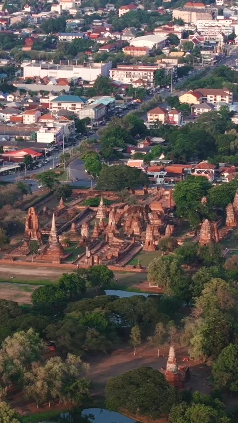 Vertical distant drone view of the ancient ruins of Wat Mahathat in Ayutthaya Stock Footage 316457279