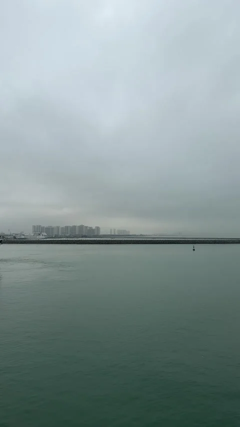 Vertical Distant View of Coastal City from Open Sea 4K Stockbeeldmateriaal 332036988