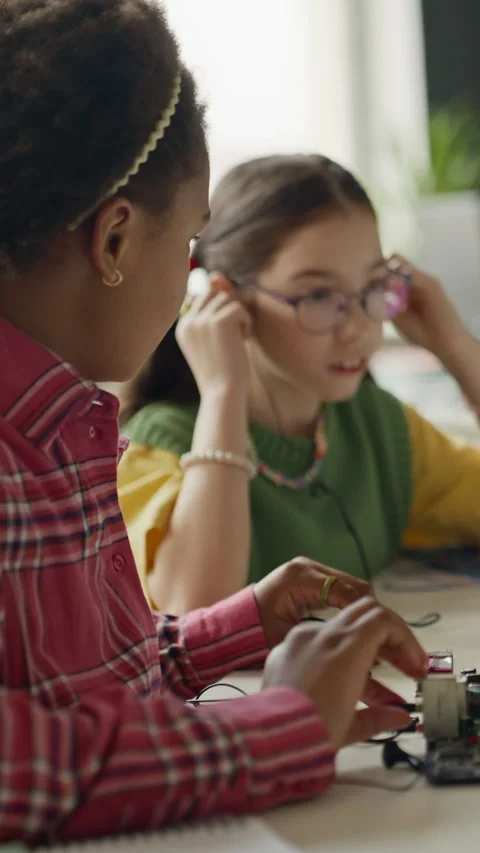 Vertical of Diverse Schoolgirls Assembling Electronic Circuit in Robotics Class Stock Footage 340547346