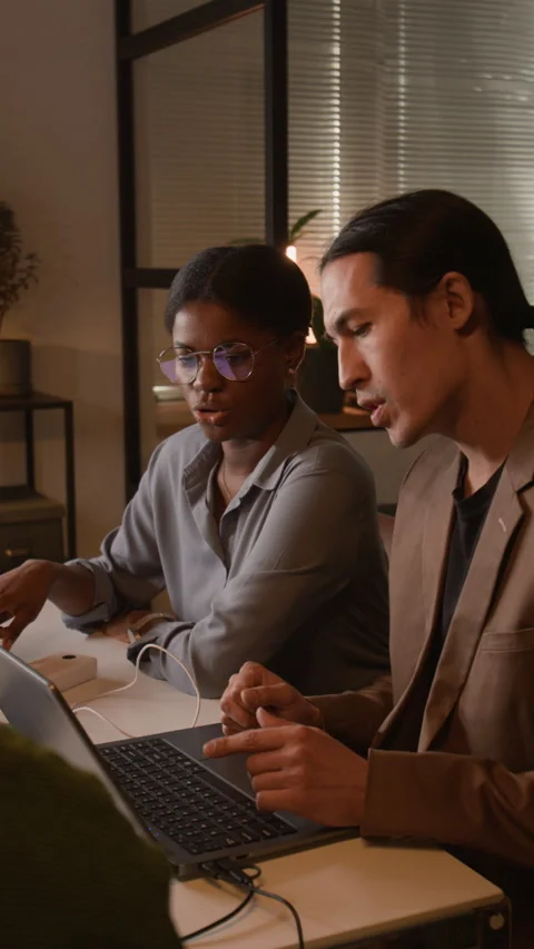Vertical of Diverse Software Developers Collaborating on Laptop in Office Stock Footage 336716962