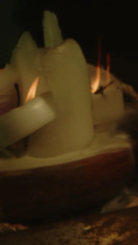 Vertical dolly of an occult altar with a burning candles and a blood filled Video stock 336369111