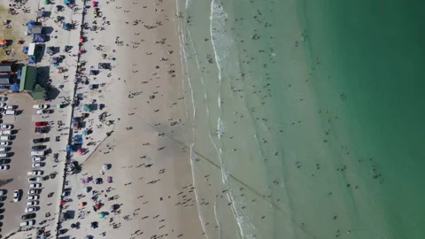 Vertical down tracking drone Shot Over Busy Fish Hoek Beach Stock-Footage 296372152