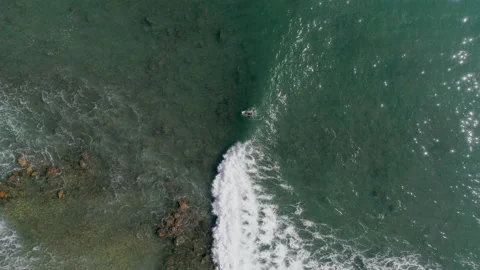 Vertical down view of surfer ride the wave. view to the ocean surfase. Stock Footage 153418181