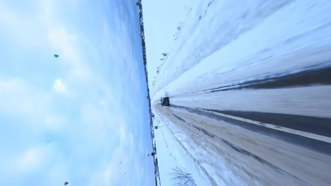 Vertical, Dramatic FPV Aerial View, Chasing Car on Icy Road in Cold Winter Stock Footage 195105465