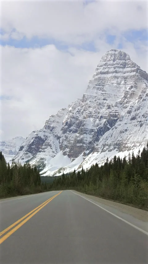 Vertical driver POV on Icefields Parkway in snowy Banff mountains Stock Footage 337826741