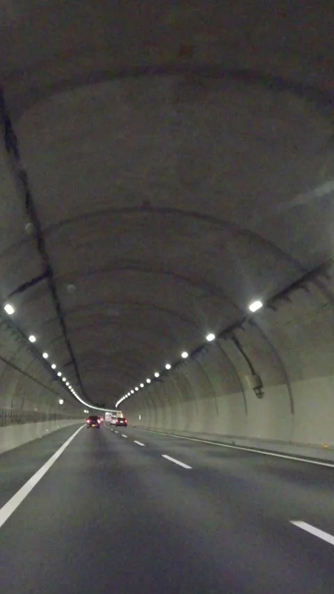 Vertical driving pov inside tunnel highway lights, driver's point of view dark Stock Footage 331124521