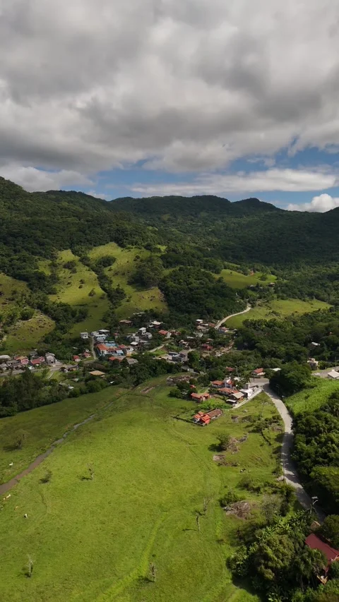 Vertical drone aerial video of mountain village and green valley in Santa Stock Footage 316361981