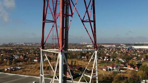 Vertical drone ascent alongside communication structure Stock Footage 323765015