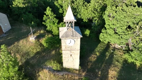 Vertical drone ascent, of the historic clock tower in a French mountain Stock Footage 312961803