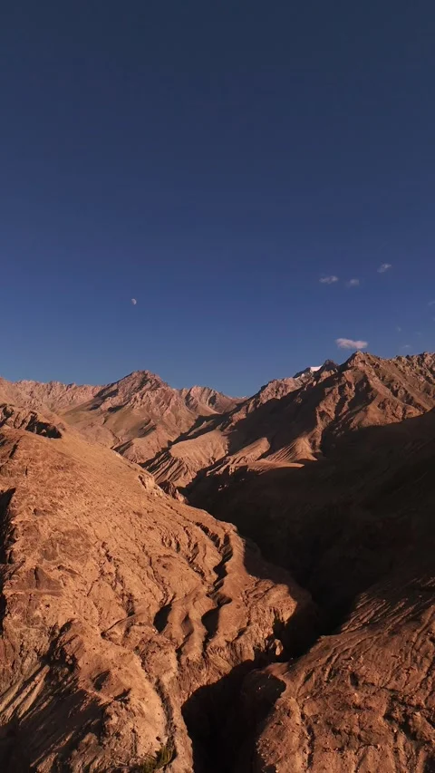 Vertical drone capture of the vast, deserted mountains of Ladakh—raw and Stock Footage 310900863