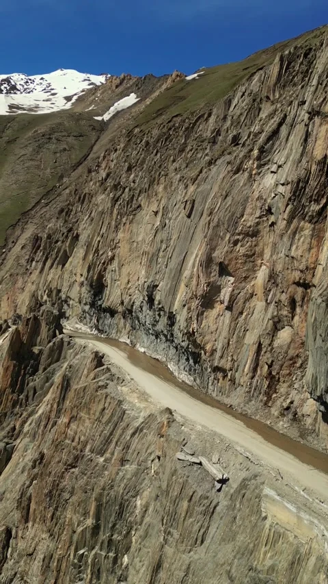 Vertical drone capture of winding roads in Zojila, Ladakh’s lifeline. Stock Footage 310807240