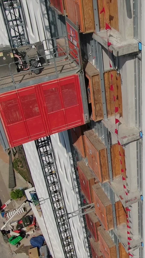 Vertical Drone Clip of Construction Elevator at High Rise Construction Site. Stock Footage 331621262