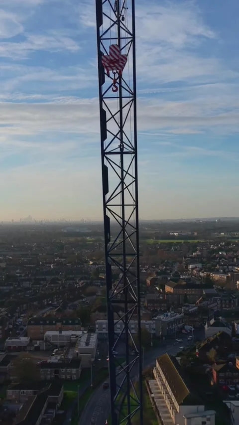 Vertical Drone Descending Shot in Front of Construction Crane Revealing Hook Stock Footage 324799672