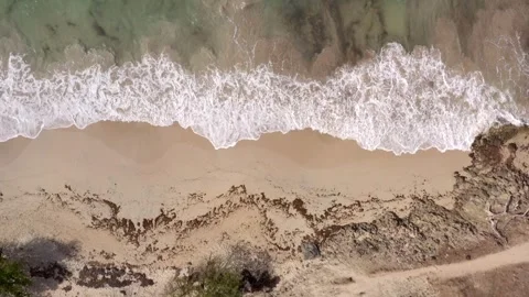Vertical Drone Descent Over Beige Sand Beach with Breaking Waves Martinique Stock Footage 317648175