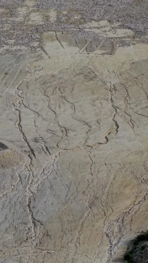Vertical drone descent over Essendon sand quarry, lunar-like terrain and alien Stock Footage 334970727