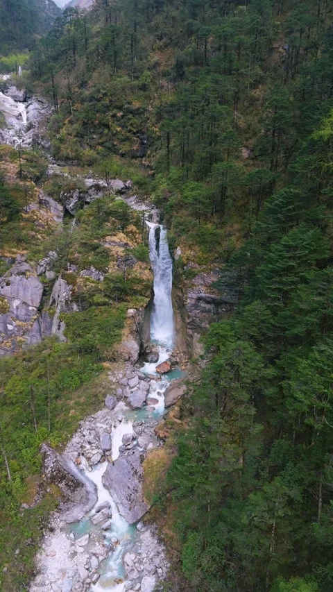 Vertical drone documenting the raw power and beauty of falling water in North Stock Footage 311502645