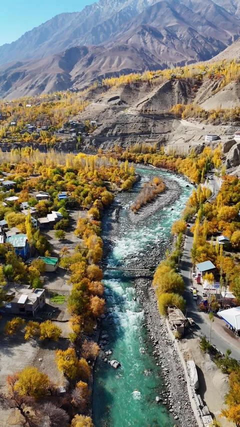 Vertical drone drifts over old bridge and fall woods in Kargil. Stock Footage 310665360